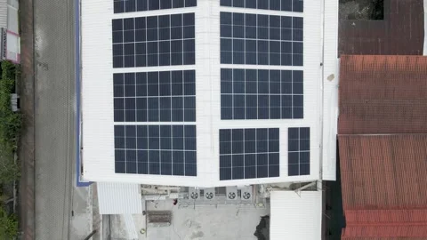 Solar panels installed on industrial warehouse roof generating renewable energy Video stock 334160886