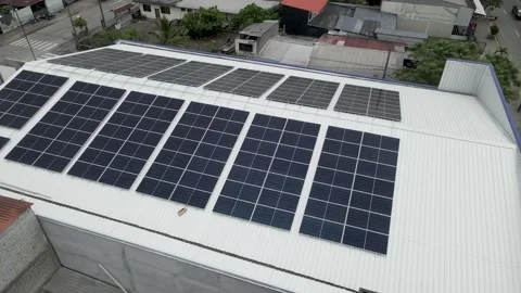 Solar panels installed on industrial warehouse roof generating renewable energy Video stock 334160912