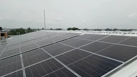 Solar panels installed on industrial warehouse roof generating renewable energy Video stock 334160942