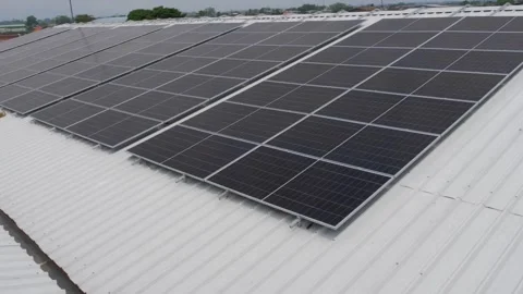 Solar panels installed on industrial warehouse roof generating renewable energy Video stock 334161003