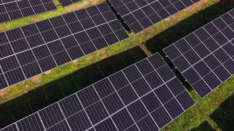 Solar panels installed in a large field during daylight hours Stockbeeldmateriaal 329999550