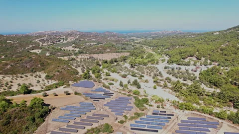 Solar panels installed in a lush landscape during sunny weather Stock Footage 290093128