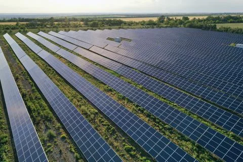 Solar panels installed outdoors, aerial view. Alternative energy source Stock Photos