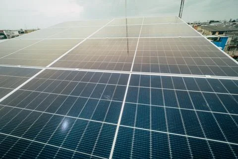 Solar panels installed on a rooftop capture sunlight during the afternoon i.. Stock Photos