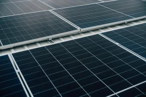 Solar panels installed on a rooftop demonstrating renewable energy solution.. Stock Photos