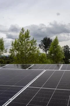 Solar panels installed on rooftop with landscape view, renewable energy system Stock Photos