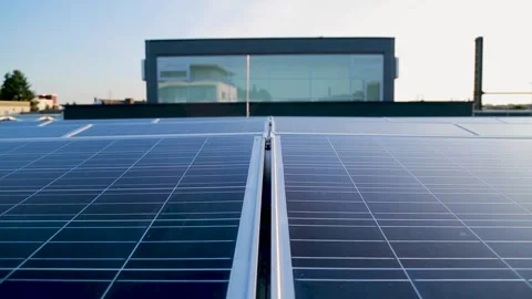 Solar Panels Installed on Rooftop with Modern Building in Urban Environment Stock Footage 334054013