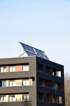 Solar Panels Installed on Rooftop of Modern Residential Apartment Building Stock Photos