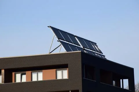Solar Panels Installed on Rooftop of Modern Residential Apartment Building Stock Photos