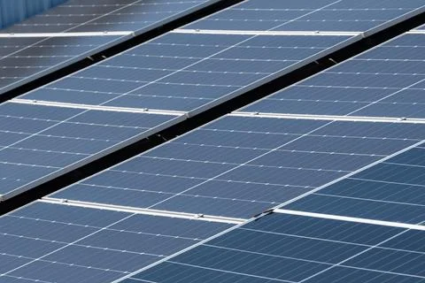 Solar panels installed on a rooftop, showcasing renewable energy technology.. Stock Photos