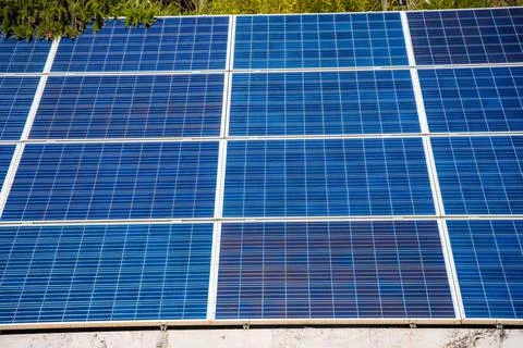 Solar panels installed on a rooftop, showcasing blue photovoltaic cells under Stock Photos