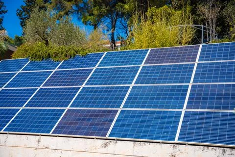 Solar panels installed on a rooftop, showcasing blue photovoltaic cells under Stock Photos