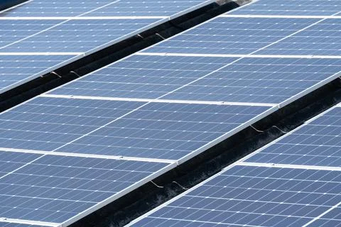 Solar panels installed on rooftops harnessing sunlight for energy productio.. Stock Photos