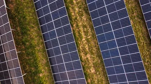 Solar panels installed in rows with grass background Stock Photos