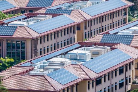 Solar panels installed on the tiled rooftops of buildings, San Francisco bay  Stock Photos