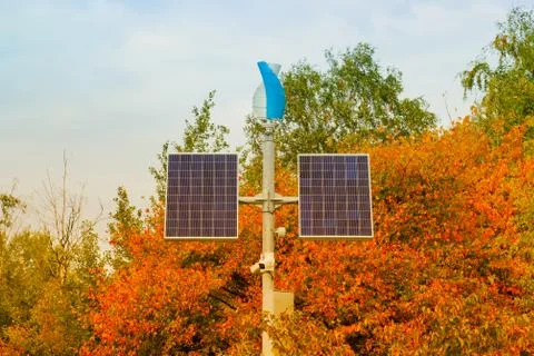 Solar panels isolated on orange tree background in autumn park Foto stock