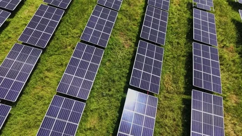 Solar panels line up on grass field in sunny weather Stock Footage 339019401