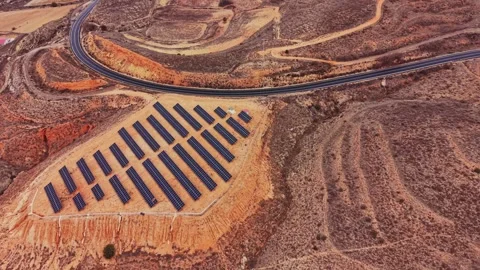 Solar panels located in rural Spain near a winding road Stock Footage 333112895