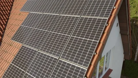 Solar panels made of solid silicon crystal on the tiled roof of a house. Video stock 255320906