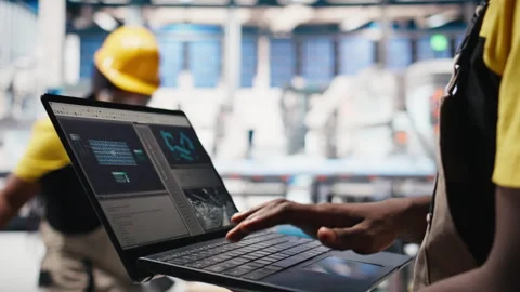 Solar panels male worker analyzing performance data on laptop Stock Footage 309072298