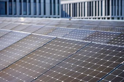 Solar panels on modern building rooftop Stock Photos
