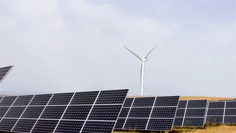 Solar panels next to a wind farm, concept of renewable energy, environmental Stock Footage 169029901