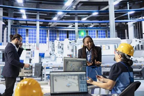 Solar panels plant engineering team doing quality control using computer Stock Photos