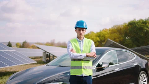 At solar panels power station posing in front of the camera ecological engineer Video stock 163975610