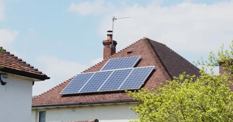 Solar panels on the roof of a house in the UK generating electricity Stock Footage