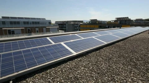 Solar panels on rooftop with city in background Stock Footage 68520037