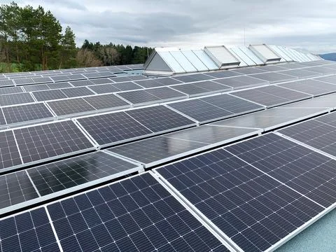 Solar panels on the rooftop of a house, using renewable energy in modern buildin Stock Photos