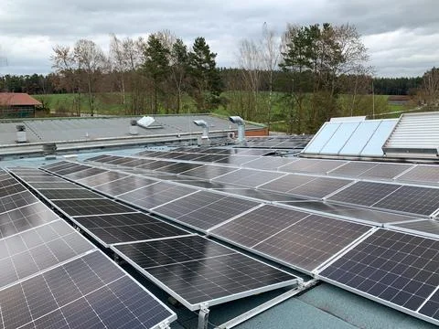 Solar panels on the rooftop of a house, using renewable energy in modern buildin Stock Photos