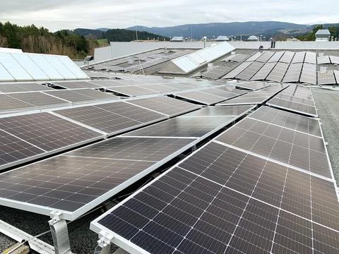 Solar panels on the rooftop of a house, using renewable energy in modern buildin Stock Photos