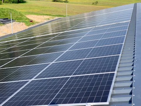 Solar panels on the rooftop of a house, using renewable energy in modern buildin Stock Photos