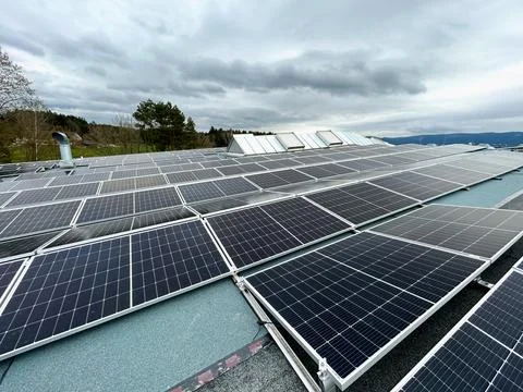 Solar panels on the rooftop of a house, using renewable energy in modern buildin Stock Photos