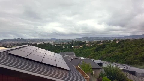 Solar panels on rooftop overlooking a hilly city Stock Footage 329190155