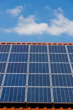 Solar panels on a rooftop, partial view Stock Photos