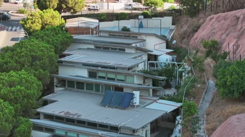 Solar panels on rooftops of buildings built on hillside of St Vincent of Paul Stock Footage 315632882