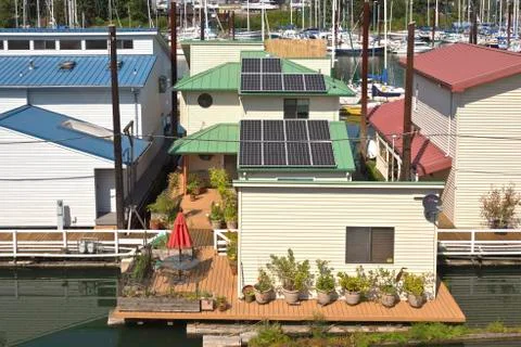Solar panels on rooftops on a floating house. Stock Photos