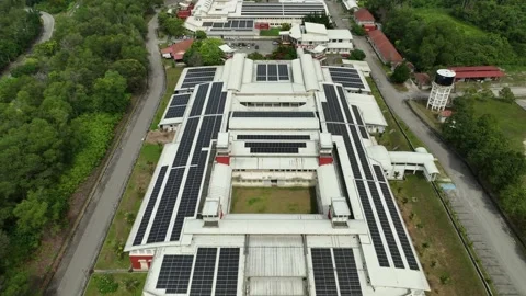 Solar panels at rooftops of large building promoting renewable energy solutions Stock Footage 311986837