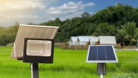 Solar panels set against a backdrop of resident, trees and a vibrant blue s.. Stock Photos
