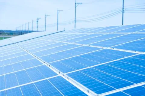 Solar panels (solar cell) in solar farm with blue sky and sun lighting Stock Photos