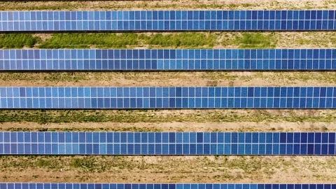 Solar panels for solar energy in a rows on the field. Aerial view Video stock 139913644
