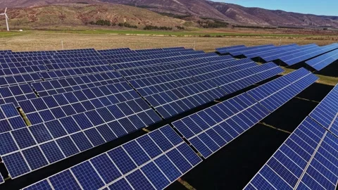 Solar panels spread across a large field in a rural area Stock Footage 334030014
