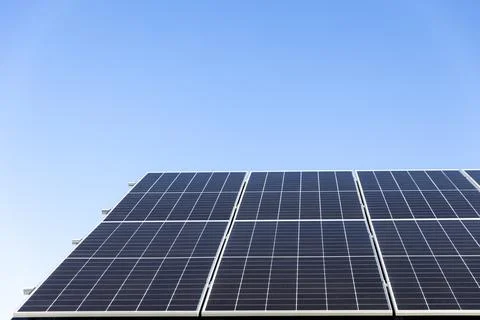 Solar panels system installed on house metal sheet roof, alternative energy Stock Photos