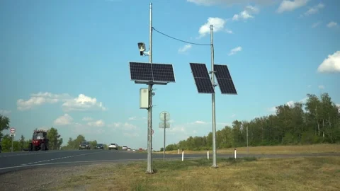 Solar panels on two poles in the steppe near the road. Camera for fixing traffic Stock Footage 209350657