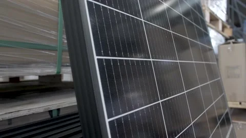 Solar panels in warehouse with large cell modules stacked, Close up orbit Stock Footage 168869762