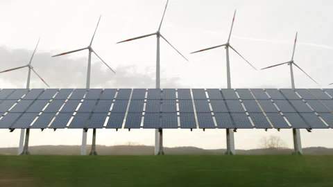 Solar panels, windmill, in nature generate electricity from air and sun Stock Footage 234860230