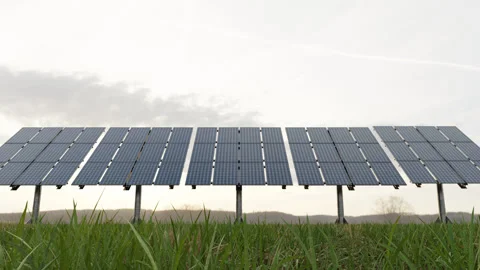 Solar panels, windmill, in nature generate electricity from air and sun Stock Footage 234860316