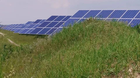 Solar park with cell panels generating green energy, grass Stock Footage 108629181